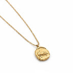 Scorpio scorpion relief gold charm necklace organic texture on white background.