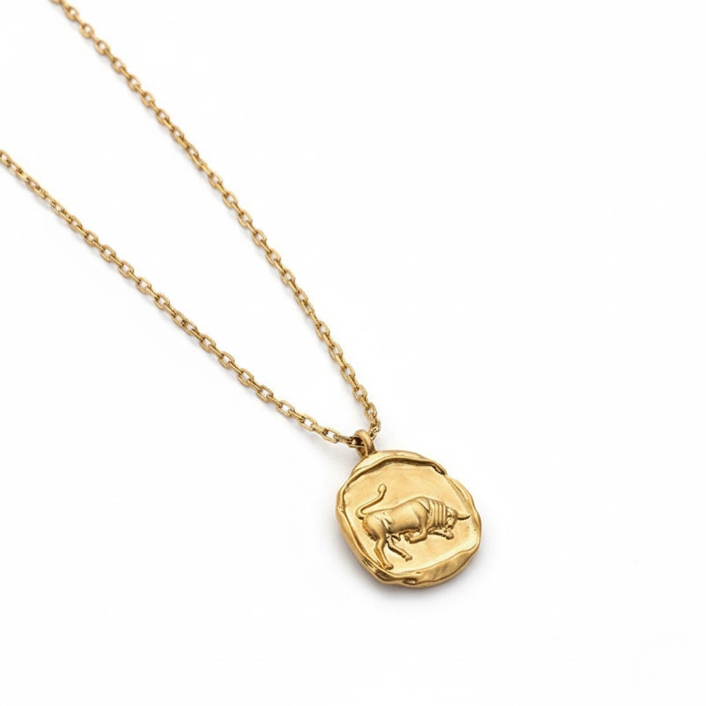 Scorpio scorpion relief gold charm necklace organic texture on white background.