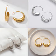 Aesthetic flat lay collage of gold and silver waterdrop earrings on white jewelry pillow.
