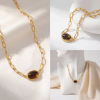 Aesthetic product photography of gold gemstone necklace on white silk and jewelry bust.