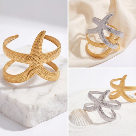 Aesthetic product photography of gold and silver starfish cuff bracelets on marble.
