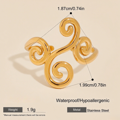 The silhouette of a model's hand against a warm, golden hour sunset. The light beautifully passes through the open filigree design of The Aphrodite Ring, making the entire piece glow as if it were magical.