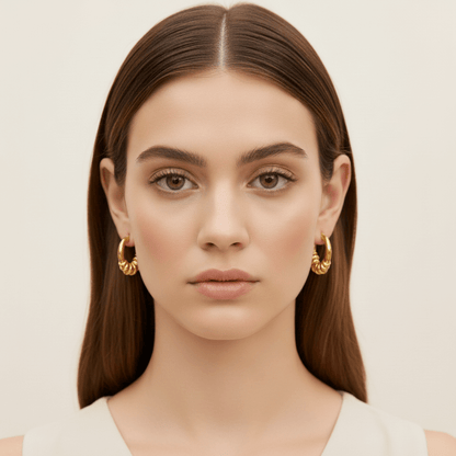 Model wearing the gold Siena Hoops to show their medium size and how they perfectly complement a modern, stylish look.