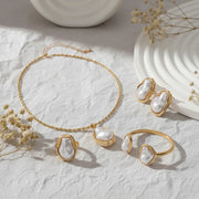 The complete Theia Goddess Set, featuring the necklace, the matching statement ring, and the earrings styled together to show a powerful, cohesive look.