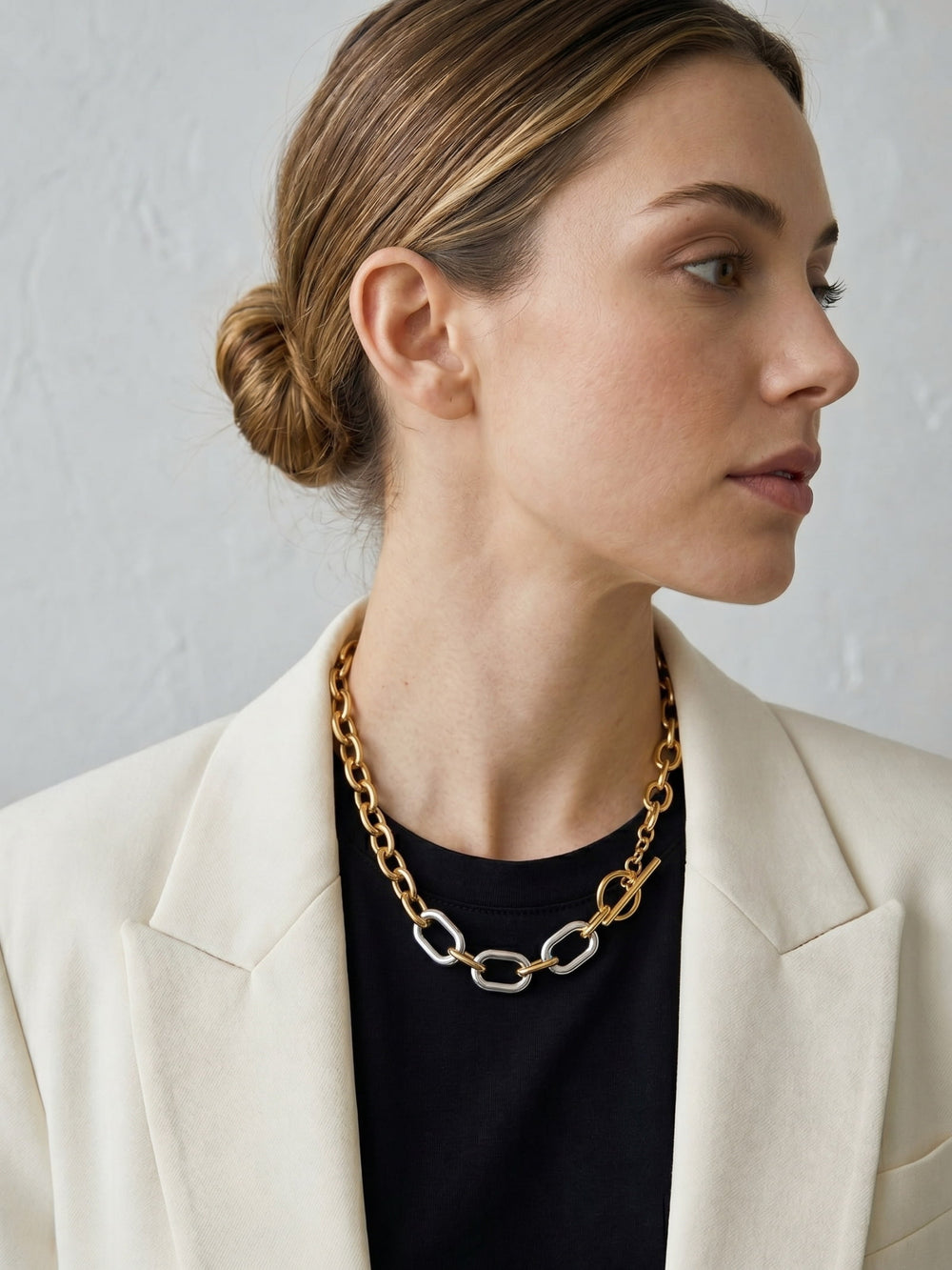 Mixed metal chunky chain necklace styled with white blazer