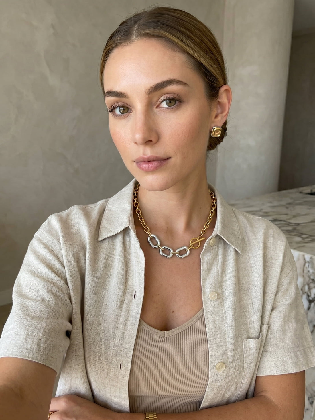 Gold and silver chunky chain necklace worn in lifestyle portrait