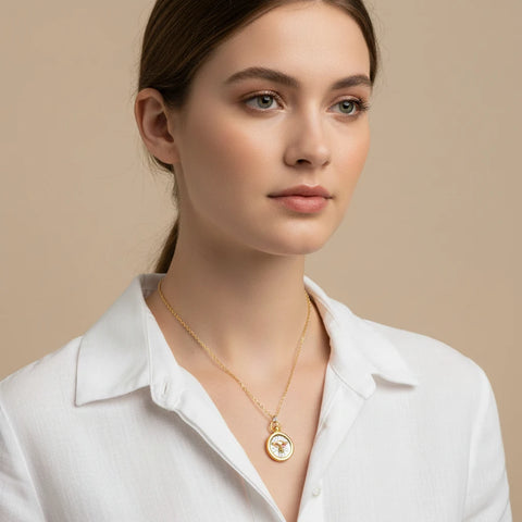Minimalist styling of two-tone zodiac necklace on woman hypoallergenic stainless steel.