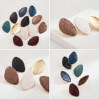 Full color collection of vintage enamel earrings flat lay including royal blue and wine red.