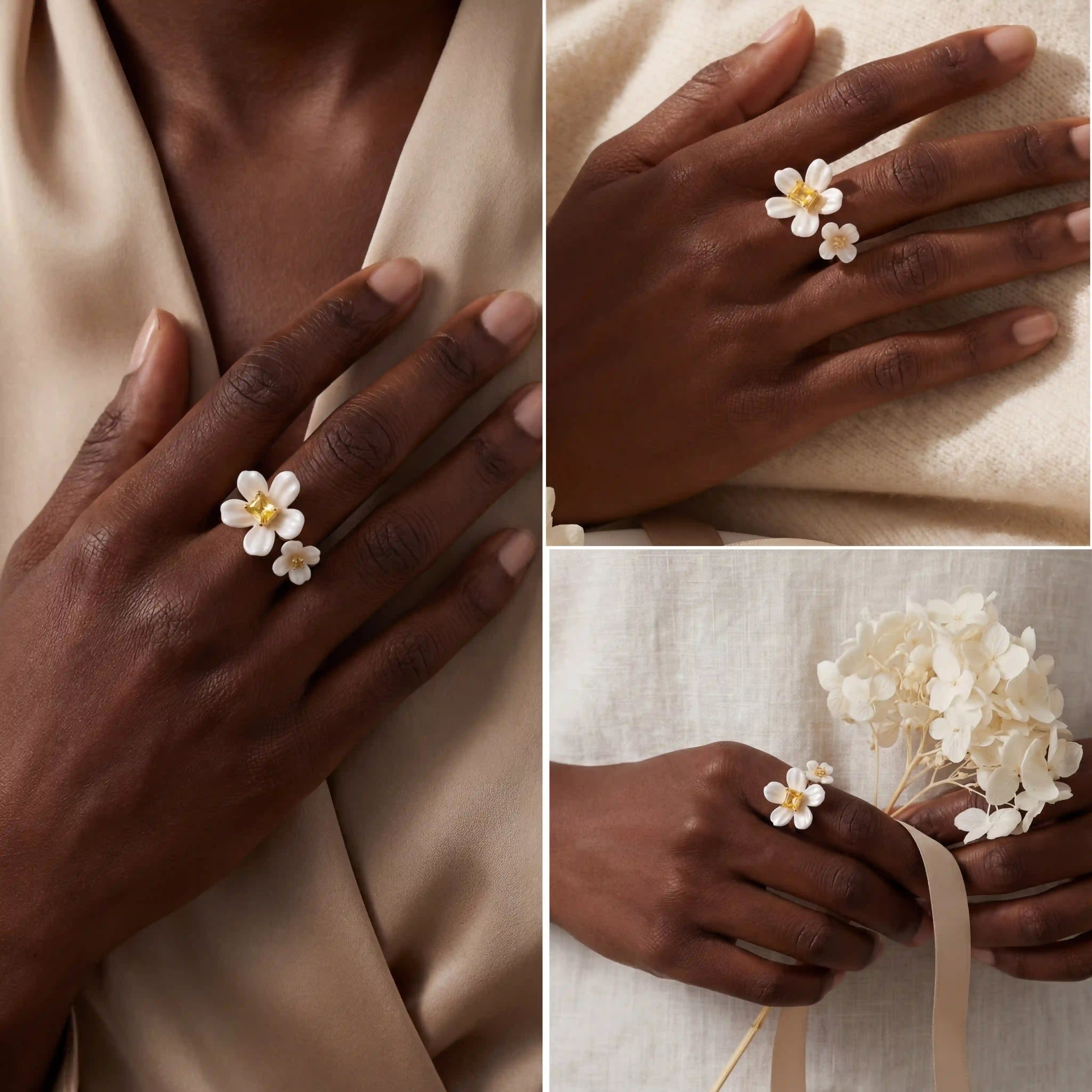 Dark skin model styling white enamel floral ring with yellow gemstone on silk background.