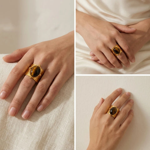 Woman wearing bohemian luxe wide gold ring with natural gemstone on middle finger.