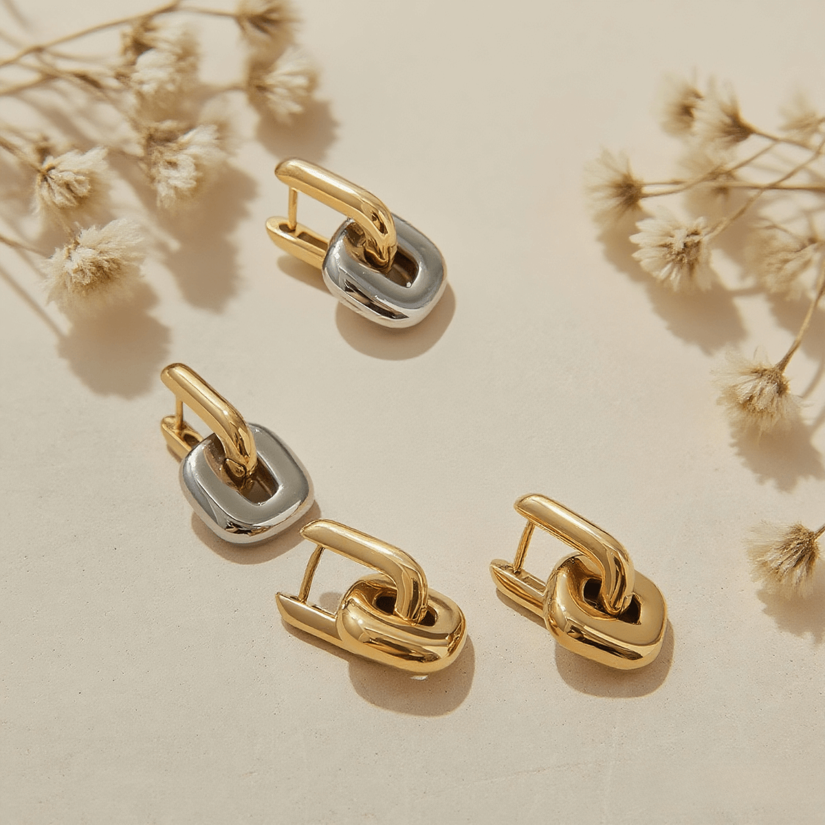 Urban Link Earrings — bold link earrings in polished gold/dual-tone on neutral background, modern statement jewelry.