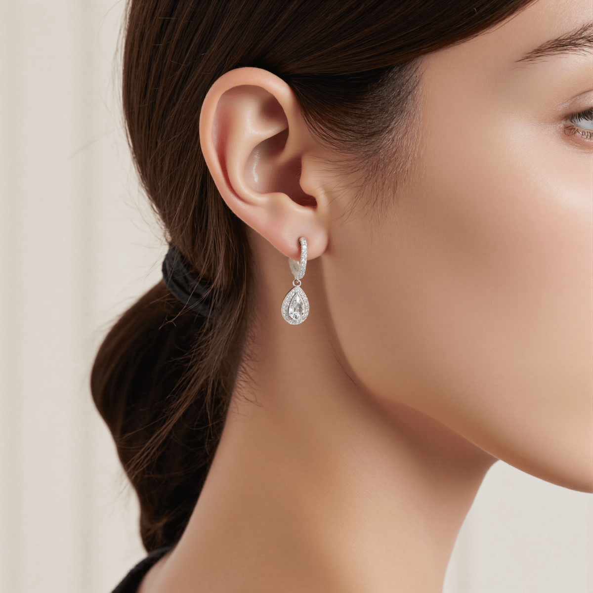 Luminous Drop Moissanite Earrings — teardrop moissanite stud earrings on a soft neutral background, radiant and elegant.