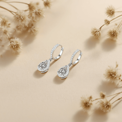 Luminous Drop Moissanite Earrings — teardrop moissanite stud earrings on a soft neutral background, radiant and elegant.