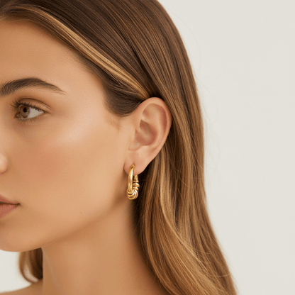 Model wearing the gold Siena Hoops to show their medium size and how they perfectly complement a modern, stylish look.