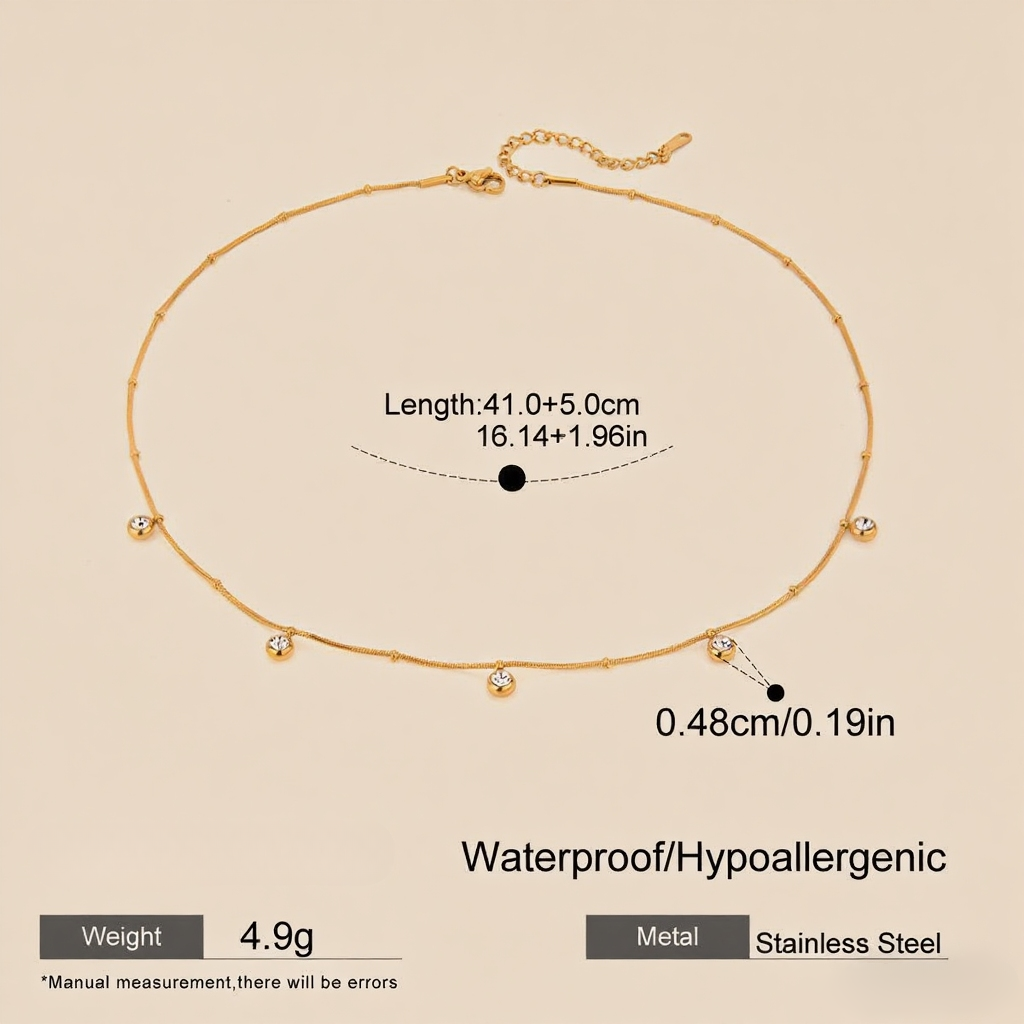 Close-up, macro shot of the smooth, reflective gold drop pendant on a delicate chain.