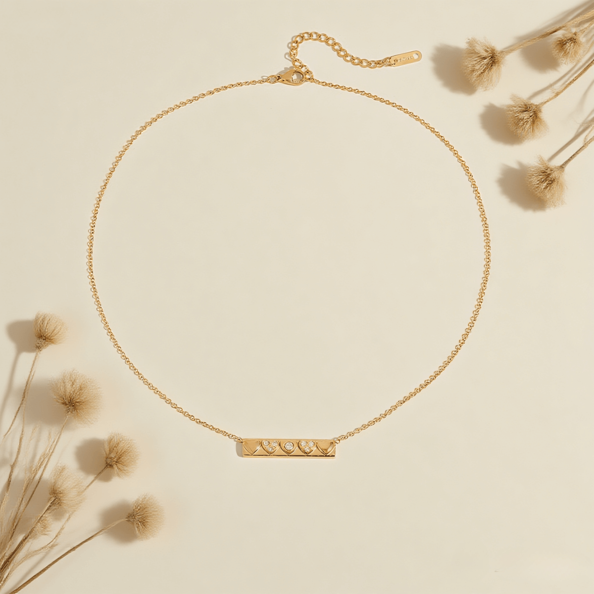 Heartline Bar Necklace — gold bar pendant with heart-shape detailing and stones, romantic and sleek.