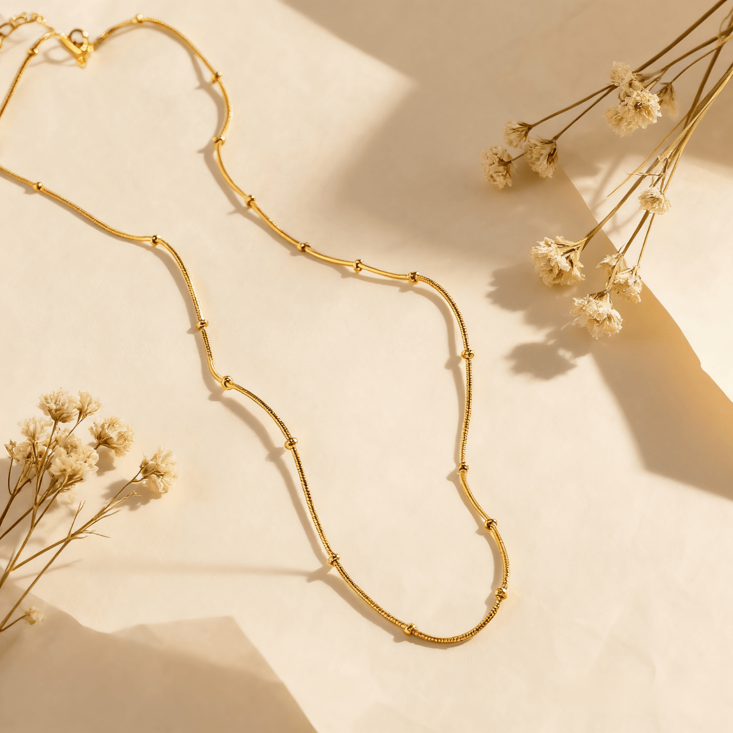 Luminova Dotted Bead Gold Necklace isolated on a white gold background, showcasing the delicate bead detail.