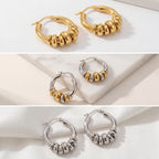 Aesthetic product photography collection of gold silver and two-tone stacked hoops on stone.