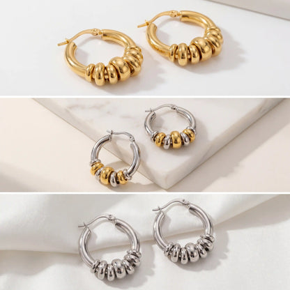 Aesthetic product photography collection of gold silver and two-tone stacked hoops on stone.