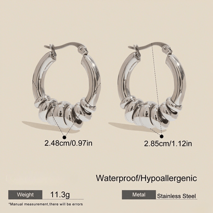 A pair of two tone Siena Stacked Hoops, highlighting the textural, multi-ring design and high-shine 18K gold-painted and polished finish.