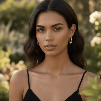 Model wearing the gold Siena Hoops to show their medium size and how they perfectly complement a modern, stylish look.