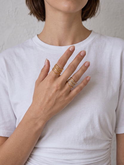 Ariadne Ring styled on the hand, showing the open adjustable multi-band silhouette