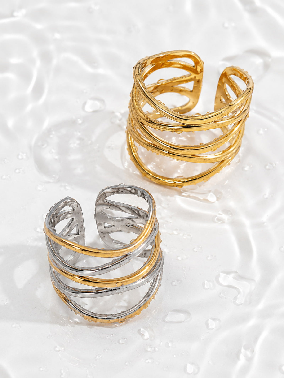 Ariadne Ring with intertwined open bands creating a layered statement ring silhouette