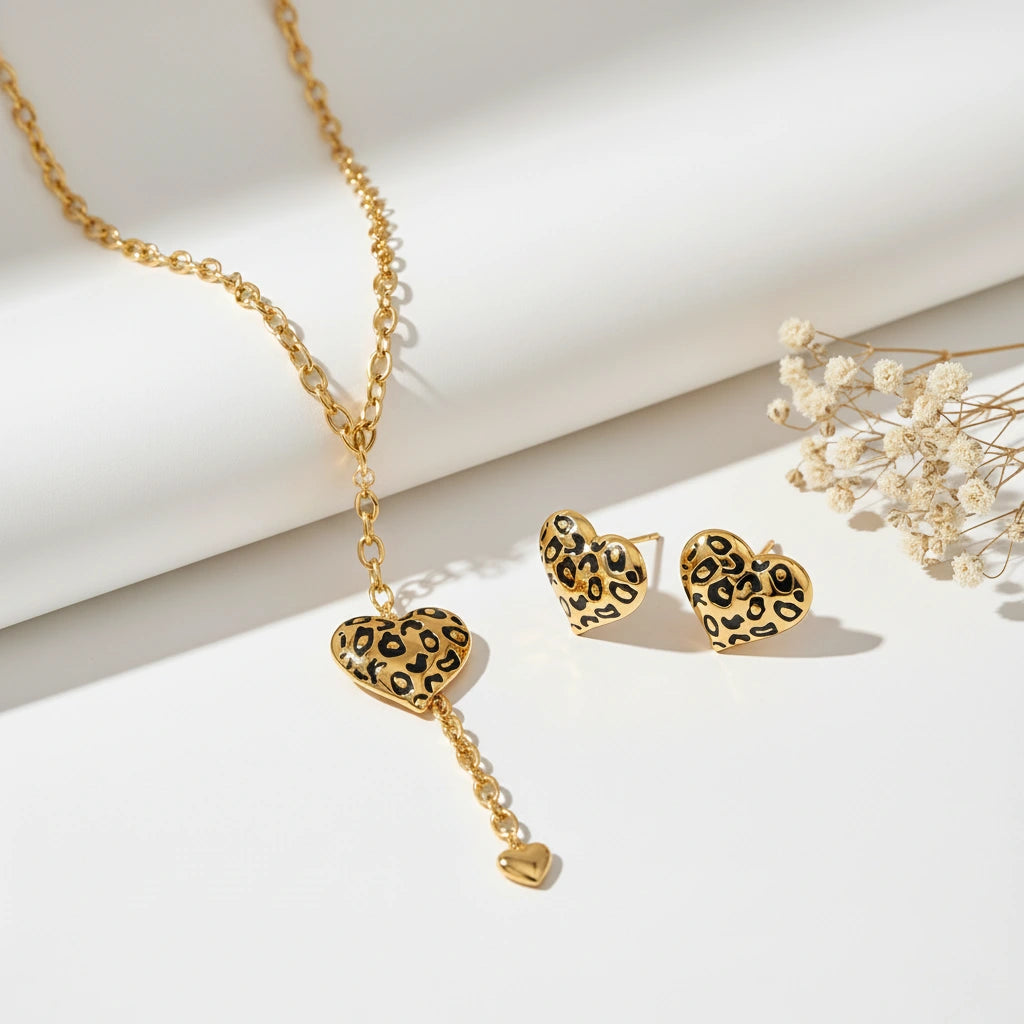 The complete Artemis wild heart set, featuring the lariat necklace and matching leopard print heart stud earrings, styled artfully together.