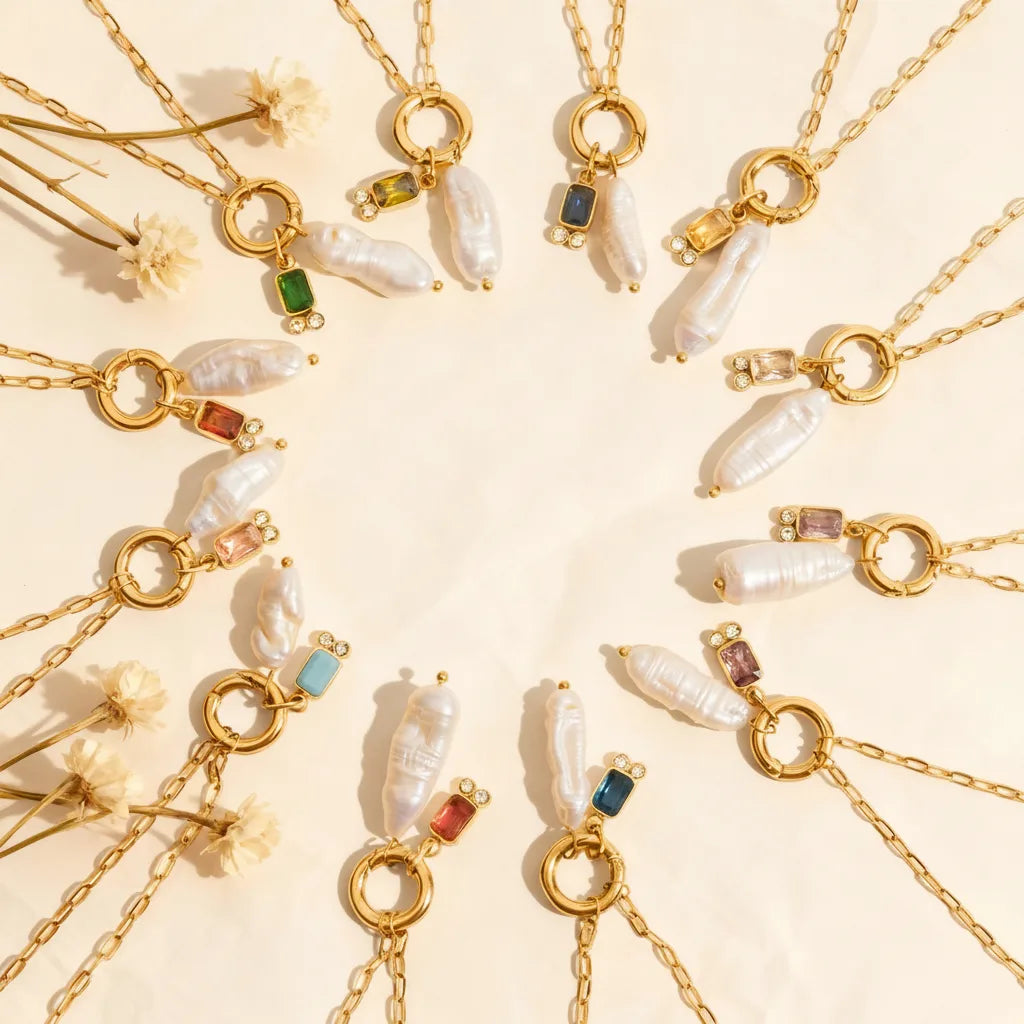 The complete collection of twelve Astoria Necklaces arranged in a celestial circle, representing each birth month with its unique gemstone and pearl