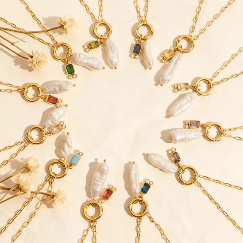 The complete collection of twelve Astoria Necklaces arranged in a celestial circle, representing each birth month with its unique gemstone and pearl