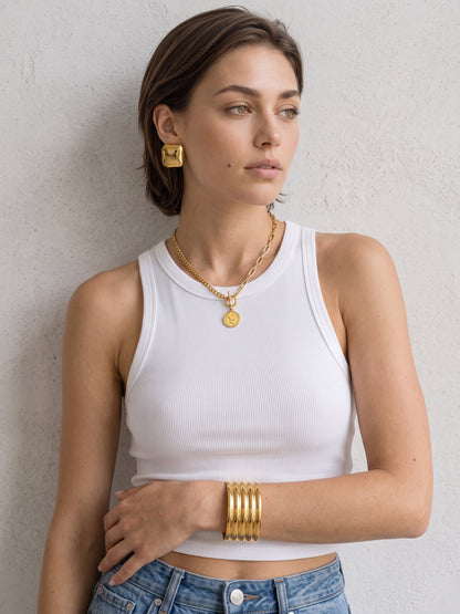 Aurelia Ribbed Cuff on the wrist, showing the chunky ribbed profile and polished gold finish