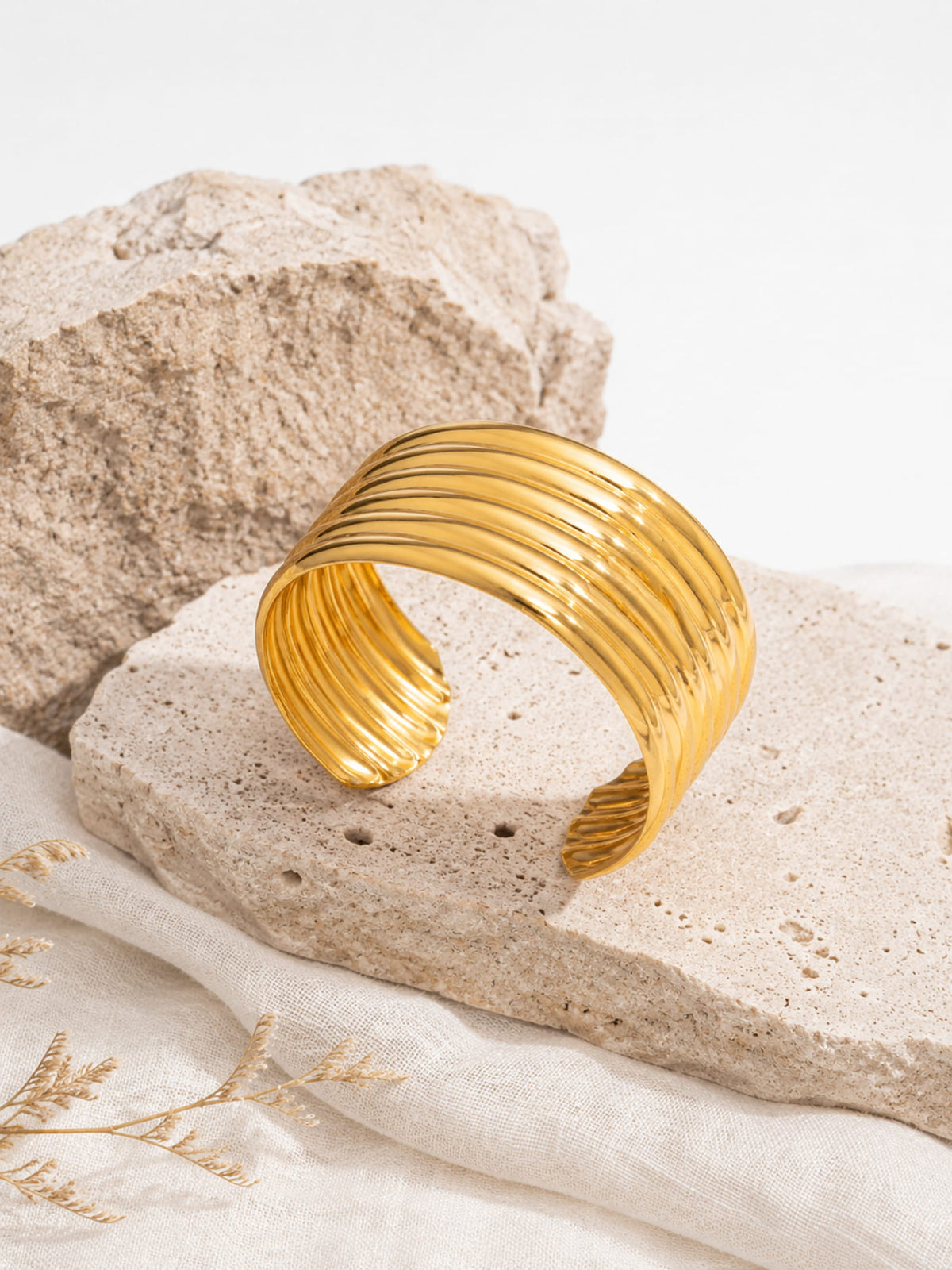 Close-up of Aurelia Ribbed Cuff showing sculptural ribbed bands and polished gold surface