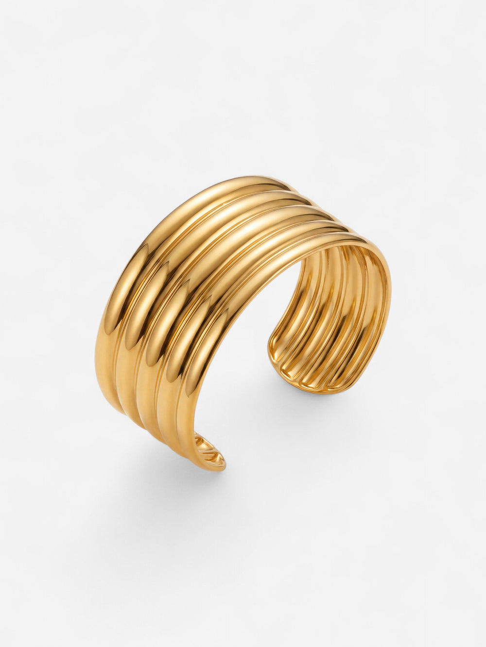 Aurelia Ribbed Cuff in polished gold with a wide open silhouette and parallel raised ribs