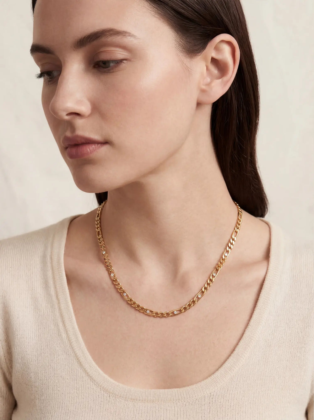 Lifestyle photography of woman wearing gold Aurelia crystal link necklace elegant everyday jewelry.