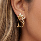 Close up of woman wearing gold Bastet crystal cat earrings whimsical animal jewelry.