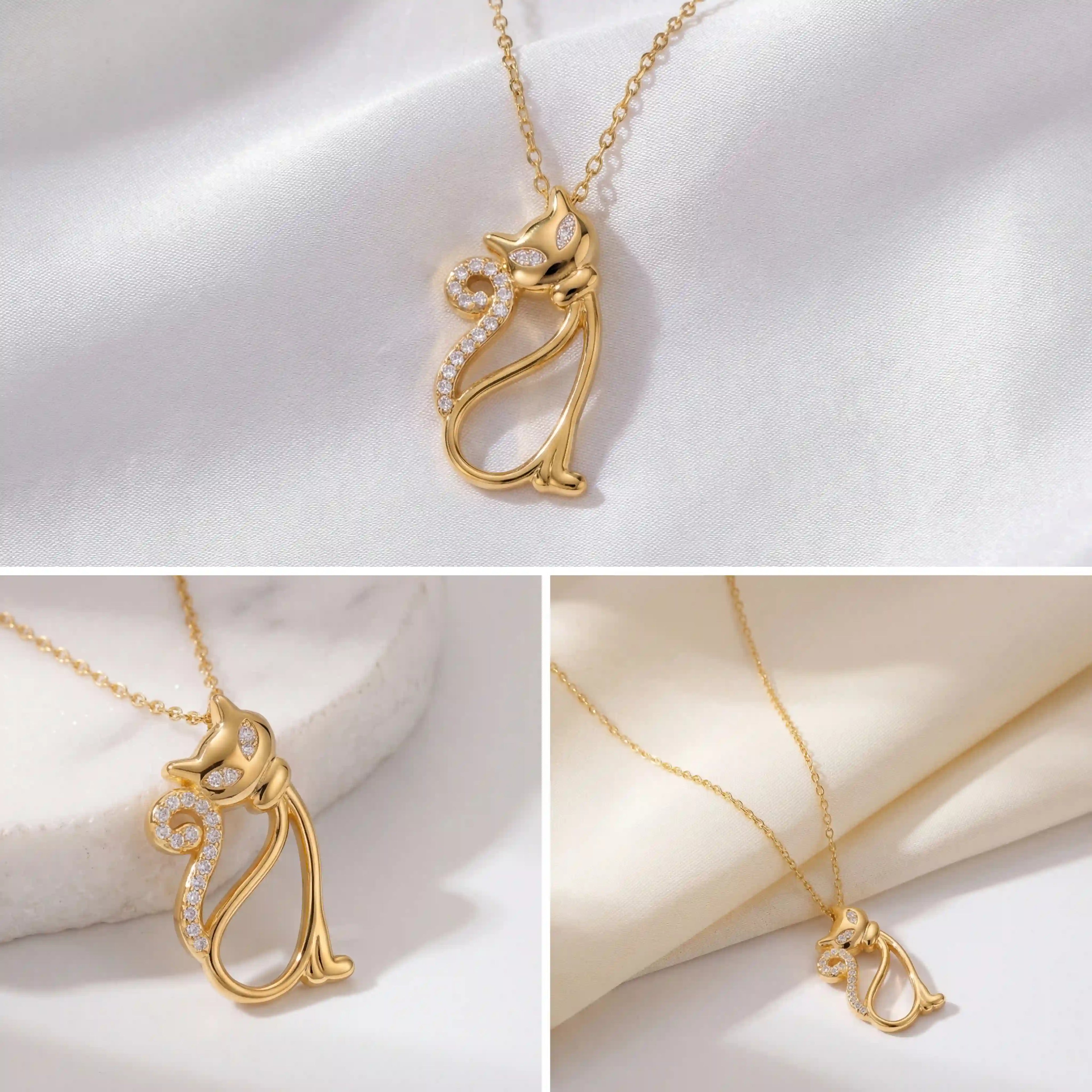 Aesthetic product photography details of gold crystal cat necklace on white silk background.
