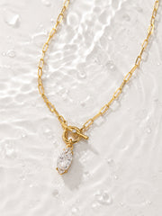 Detail view of the gold front toggle and clear marquise-cut zircon stone