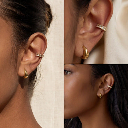 Emerald cut crystal ear cuff on dark skin tone, stackable gold ear accessories, luxury look without piercing for women.