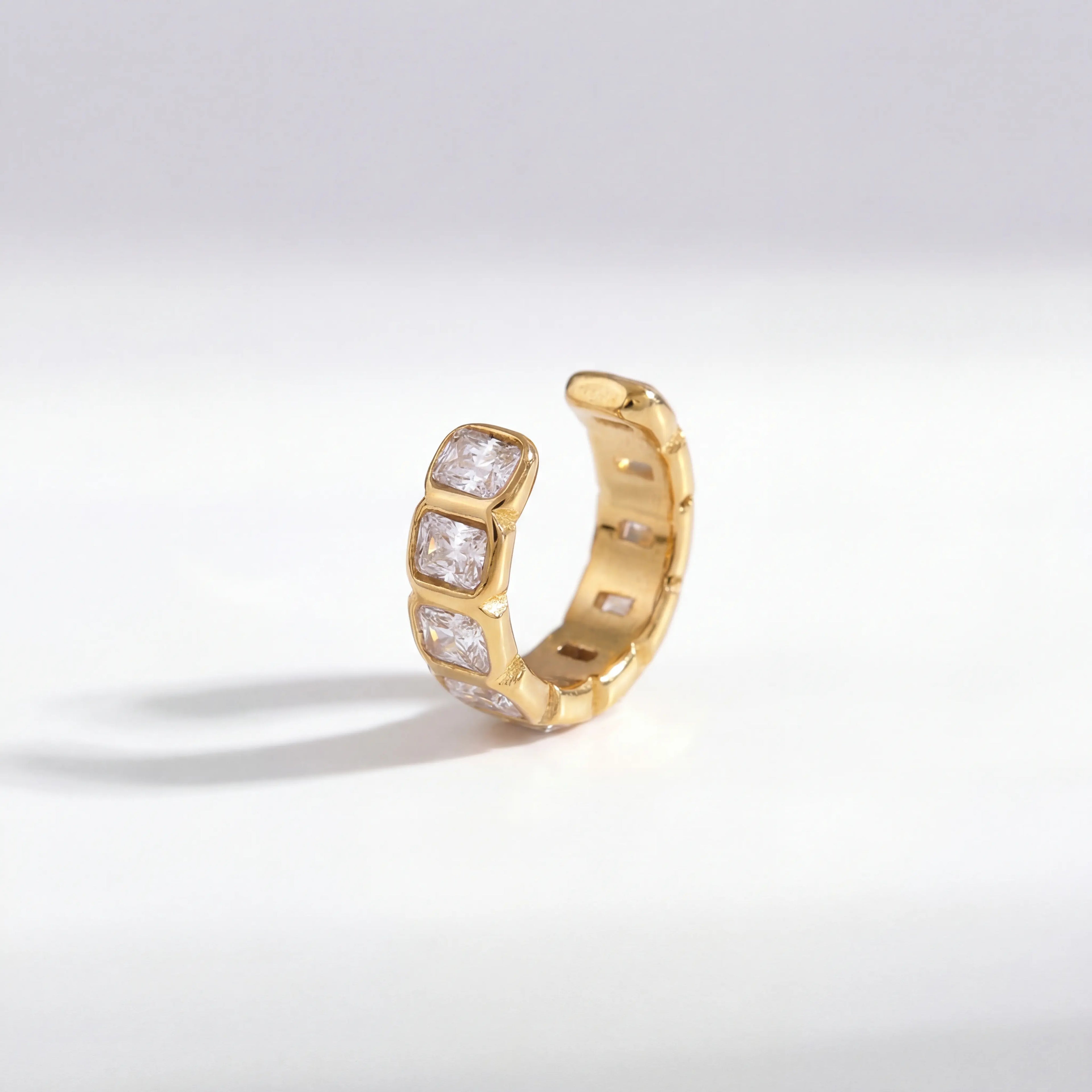 18k gold plated stainless steel ear cuff, emerald cut cubic zirconia clip on earring, waterproof non-tarnish jewelry isolated on white.