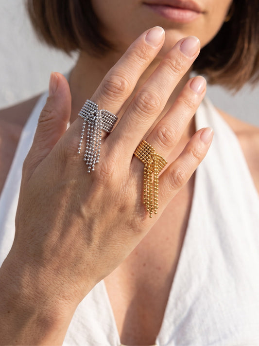 Danaë gold chain fringe ring worn on hand, showing the cascading tassel detail