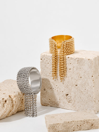 Danaë chain fringe ring close-up showing the band and cascading tassel construction