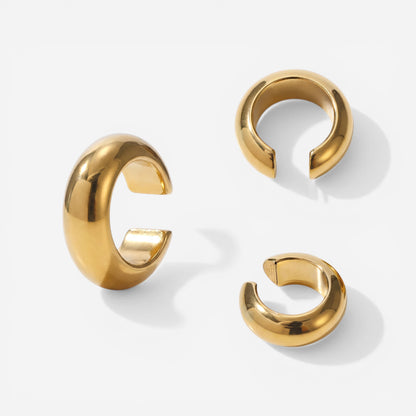 Aesthetic product photography of chunky gold dome ear cuffs minimalist jewelry.