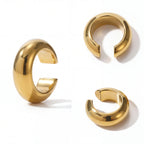 Aesthetic product photography of chunky gold dome ear cuffs minimalist jewelry.