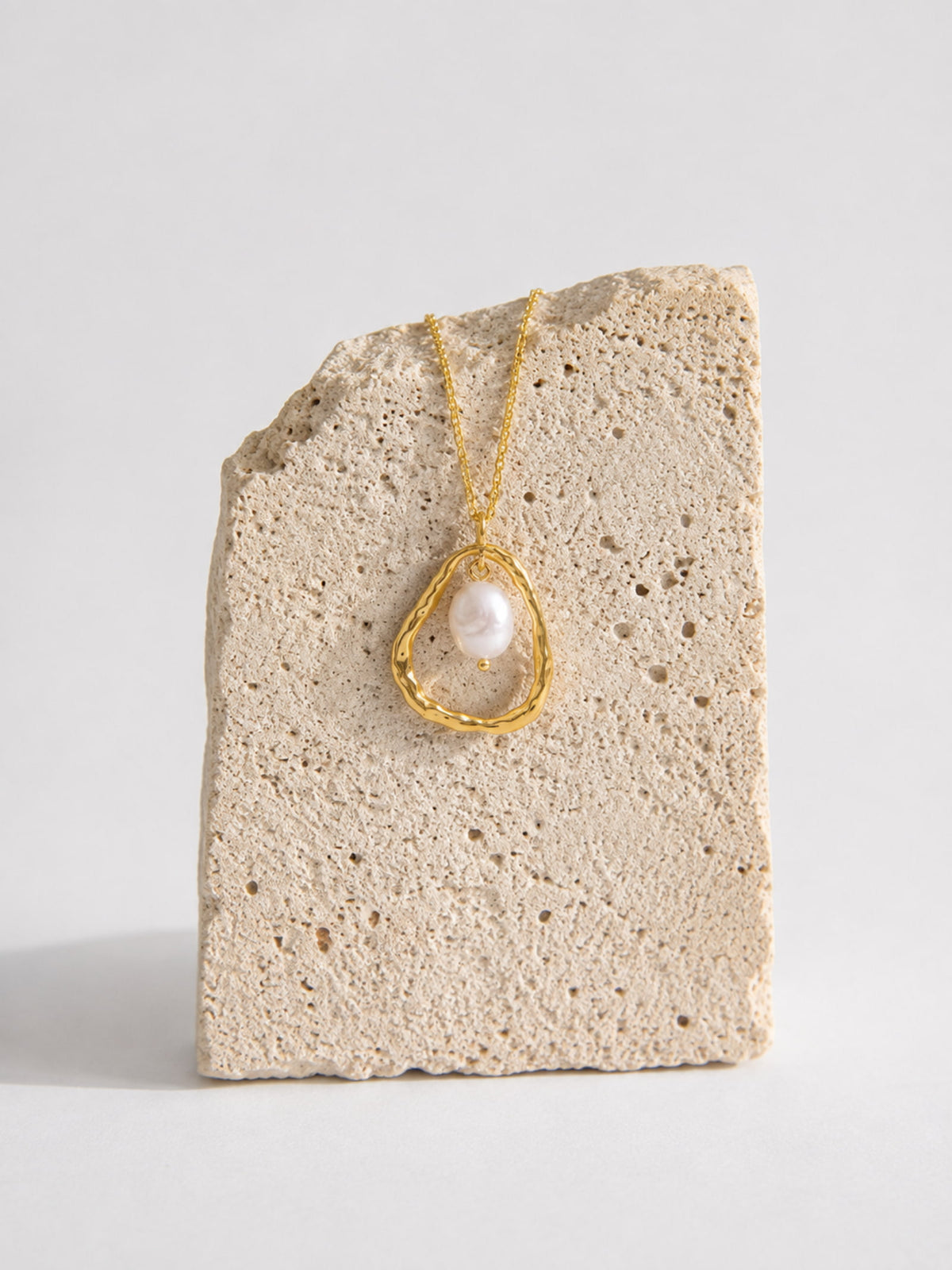 Detail view of the Luna Organic Pearl Pendant with organic gold circle and pearl drop