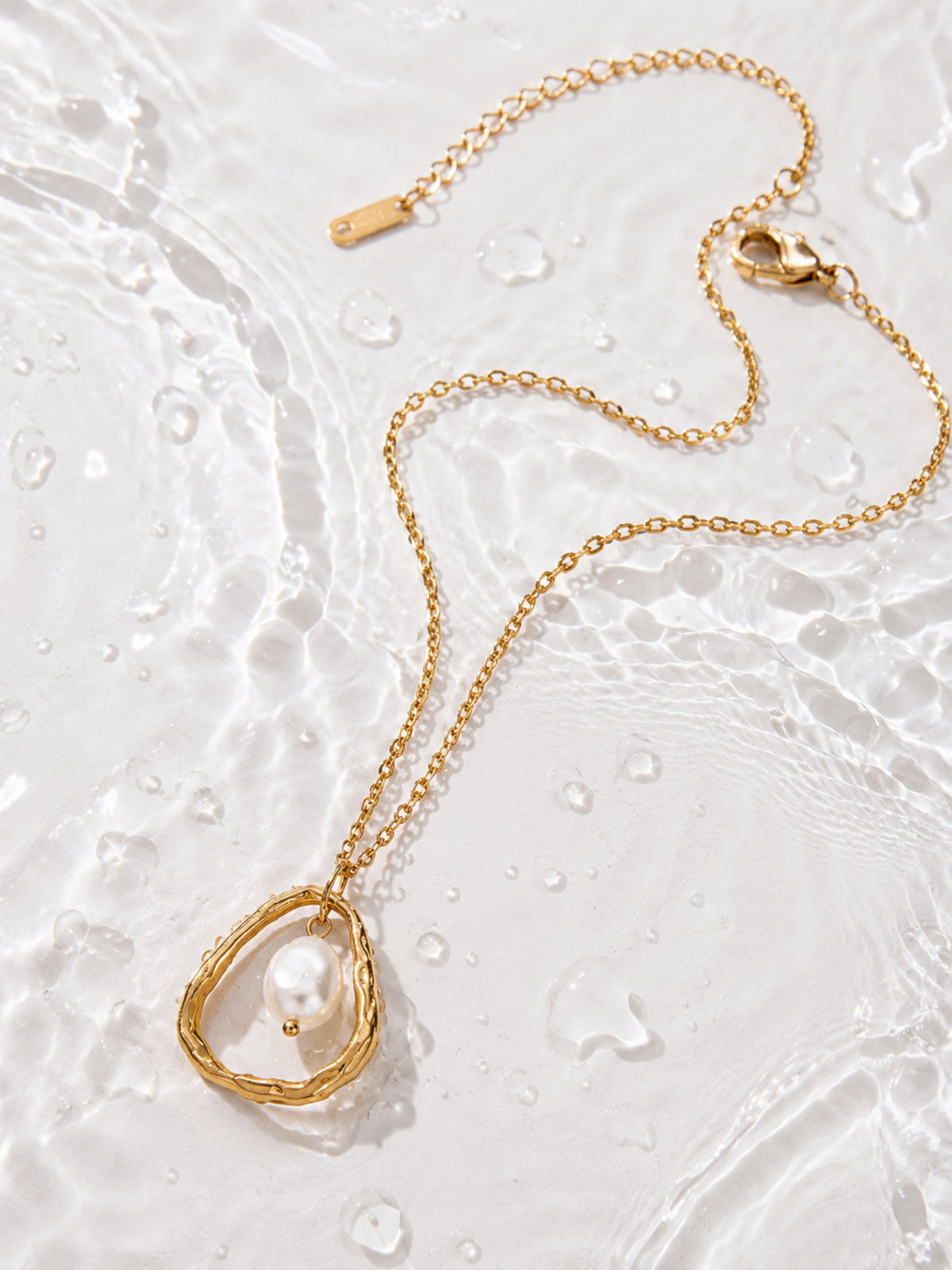 Luna Organic Pearl Pendant showing the sculpted gold frame and suspended pearl