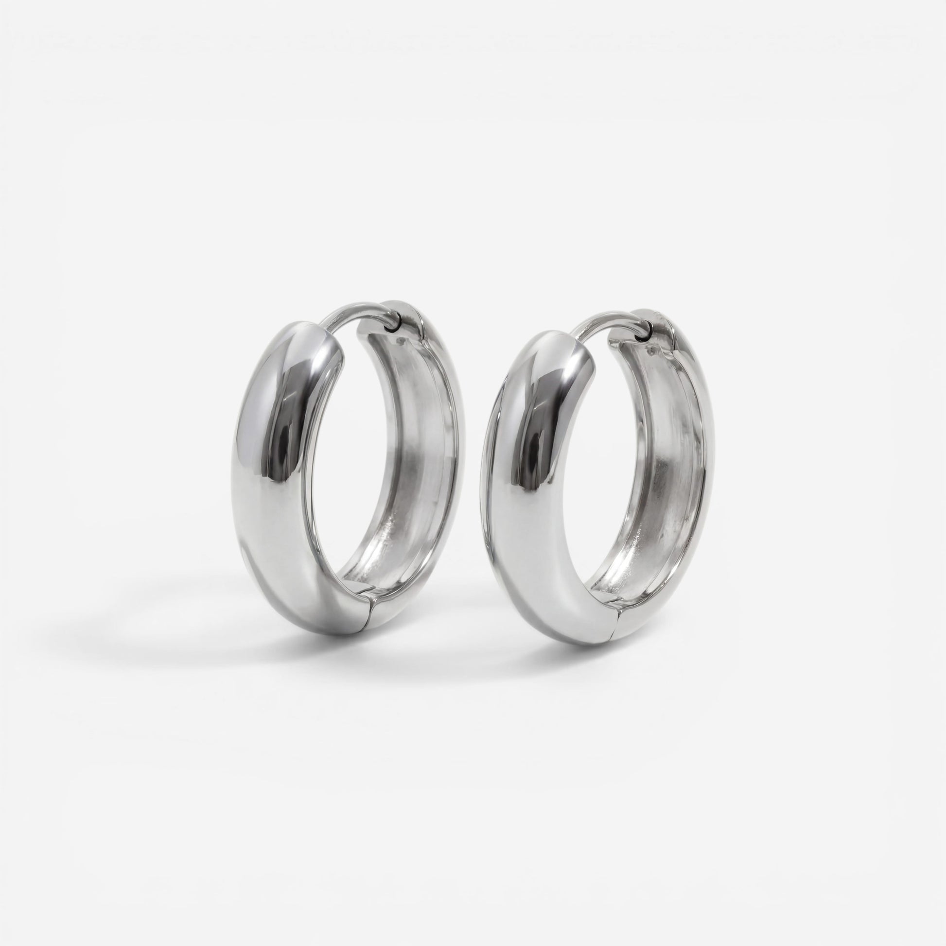 Silver chunky dome huggie earrings stainless steel minimalist design.