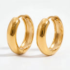 Pair of gold chunky dome hoop earrings waterproof stainless steel high polish.