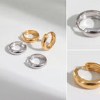 Aesthetic product photography of gold and silver chunky dome hoops collection on white stone.