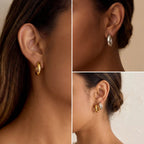 Model with dark skin styling gold Mila thick hoop earrings office wear.