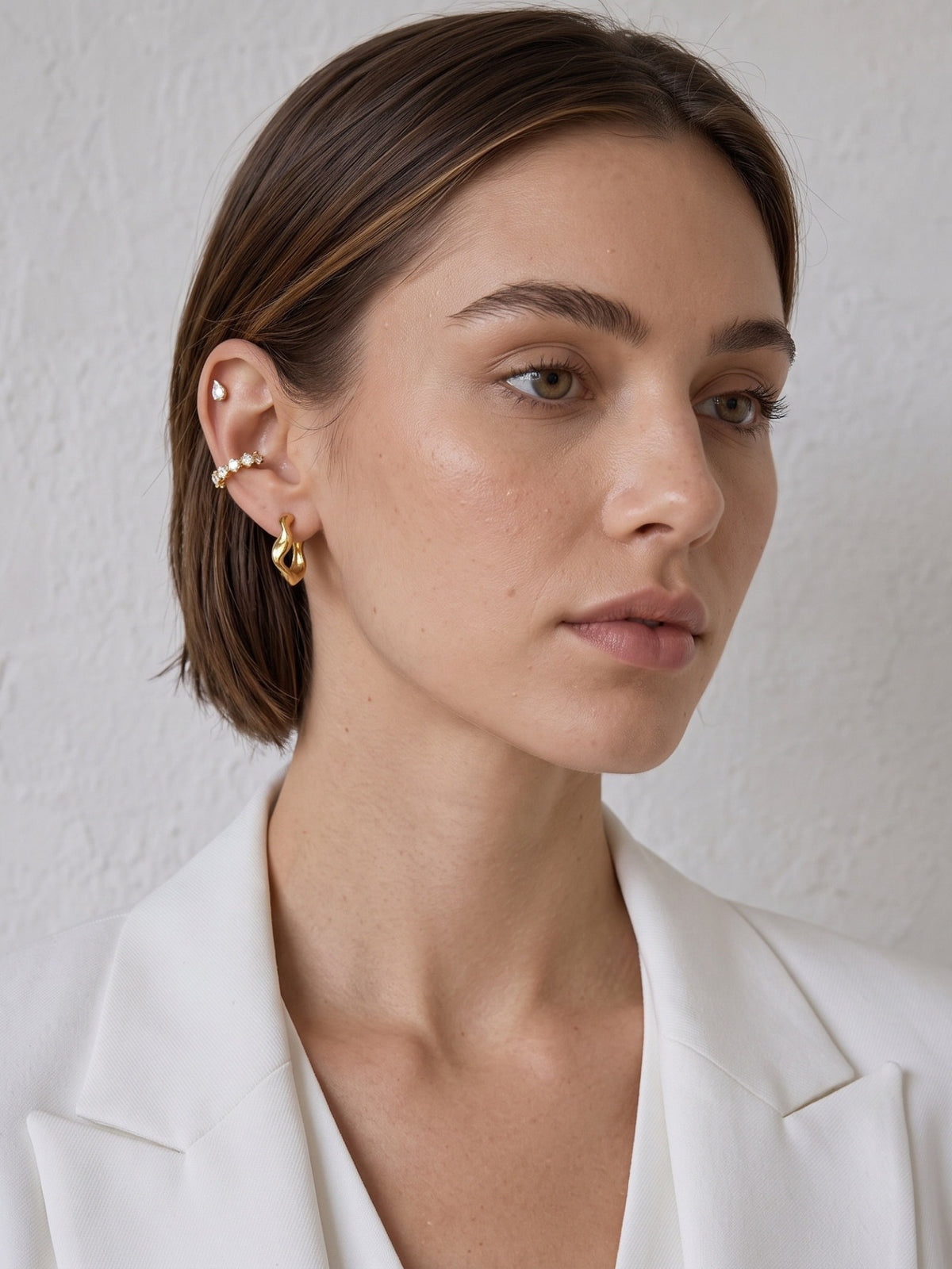 Nola Organic Wave Hoops worn on the ear, highlighting the rounded organic curves